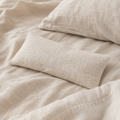 Still lavender eye pillow lying on linen bedding ready for use